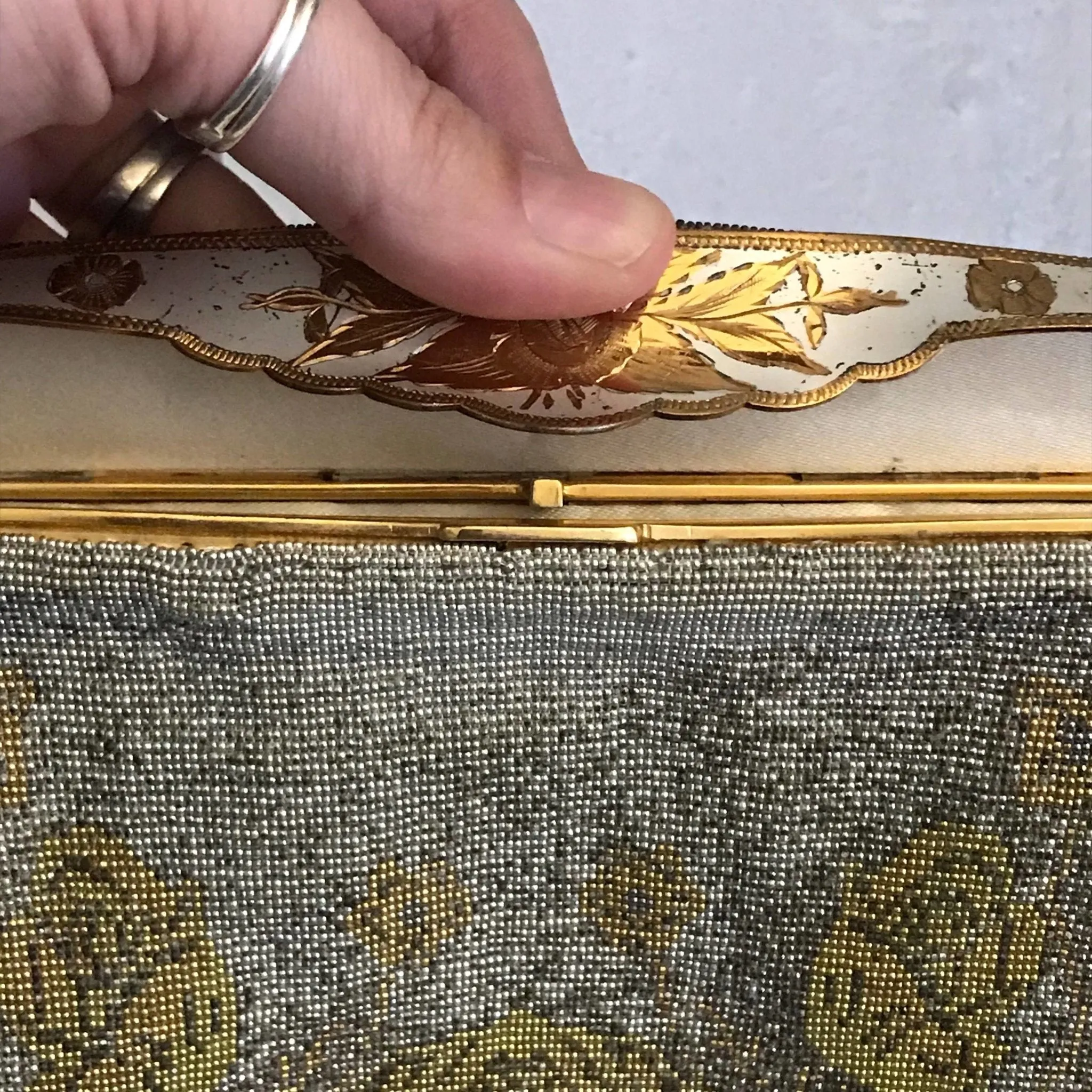 Vintage Metal Mesh Metallic Clutch in Silver and Gold with a Floral design by Saks Fifth Avenue.